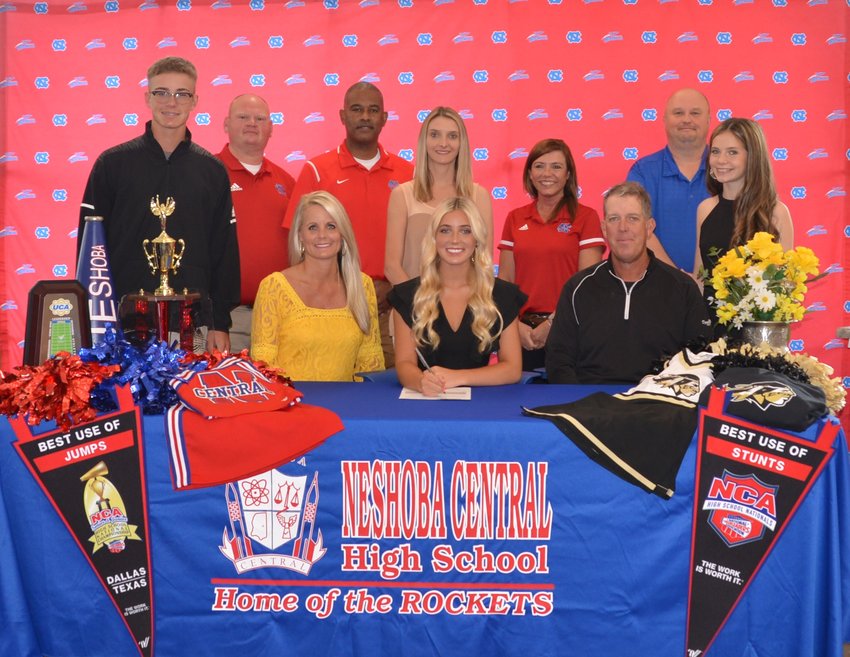 At her signing ceremony are, first row, from left her mother, Angela Fulton; Piper Fulton; and her dad, Jason Fulton. Second row, from left are her brother, Creed Fulton; assistant principal, Brent Pouncey; assistant principal LaShon Horne; Cheer Coach, Nikki Morrow; Assistant Principal, Dana McLain; and Principal Jason Gentry.